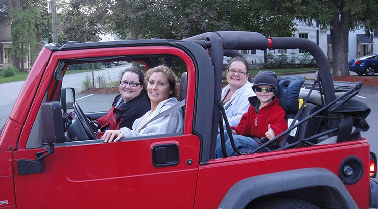 Team in a red jeep